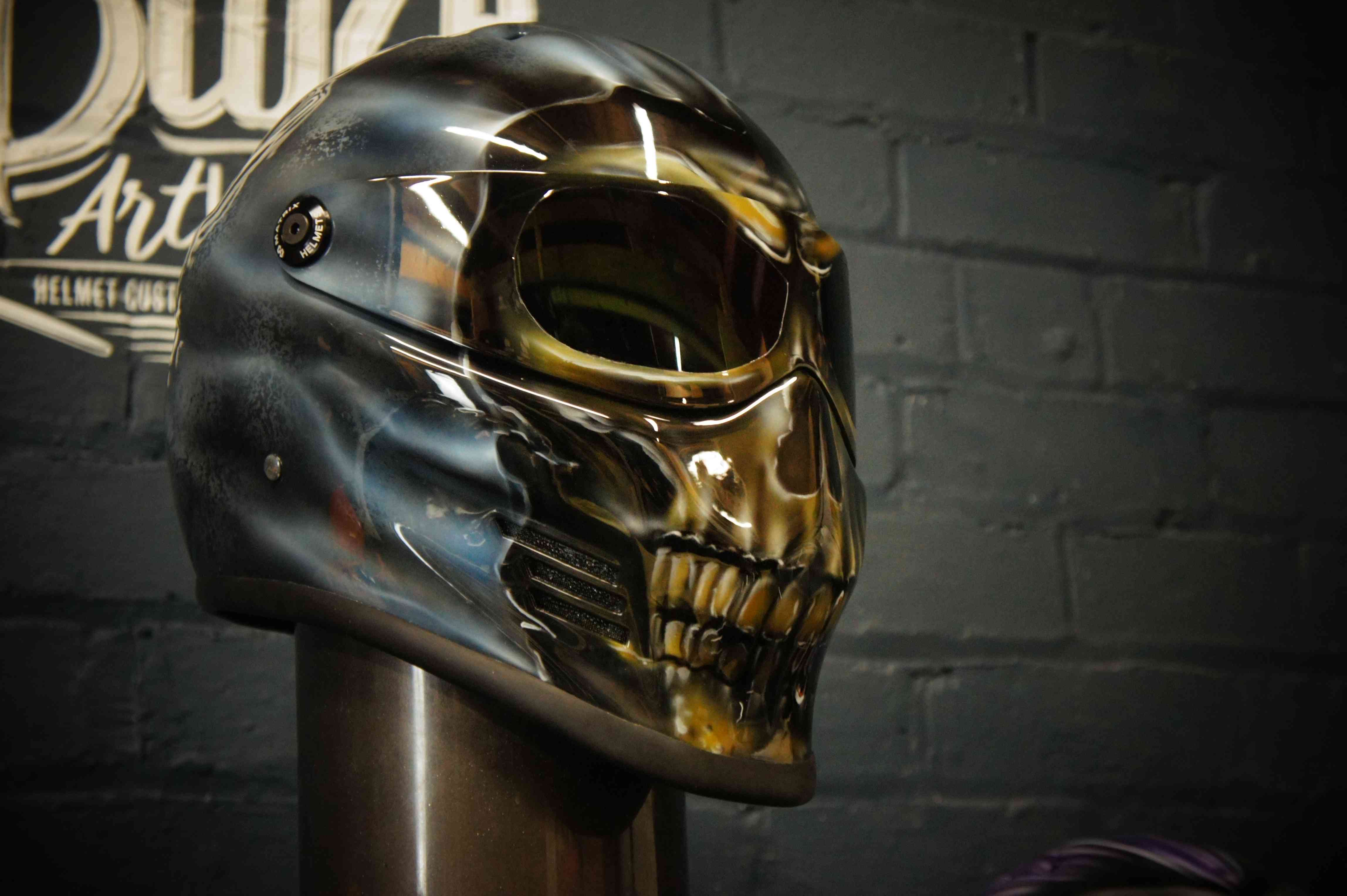 Chrome skull helmet with menacing teeth design, dark metallic finish, gothic horror style custom motorcycle helmet artwork