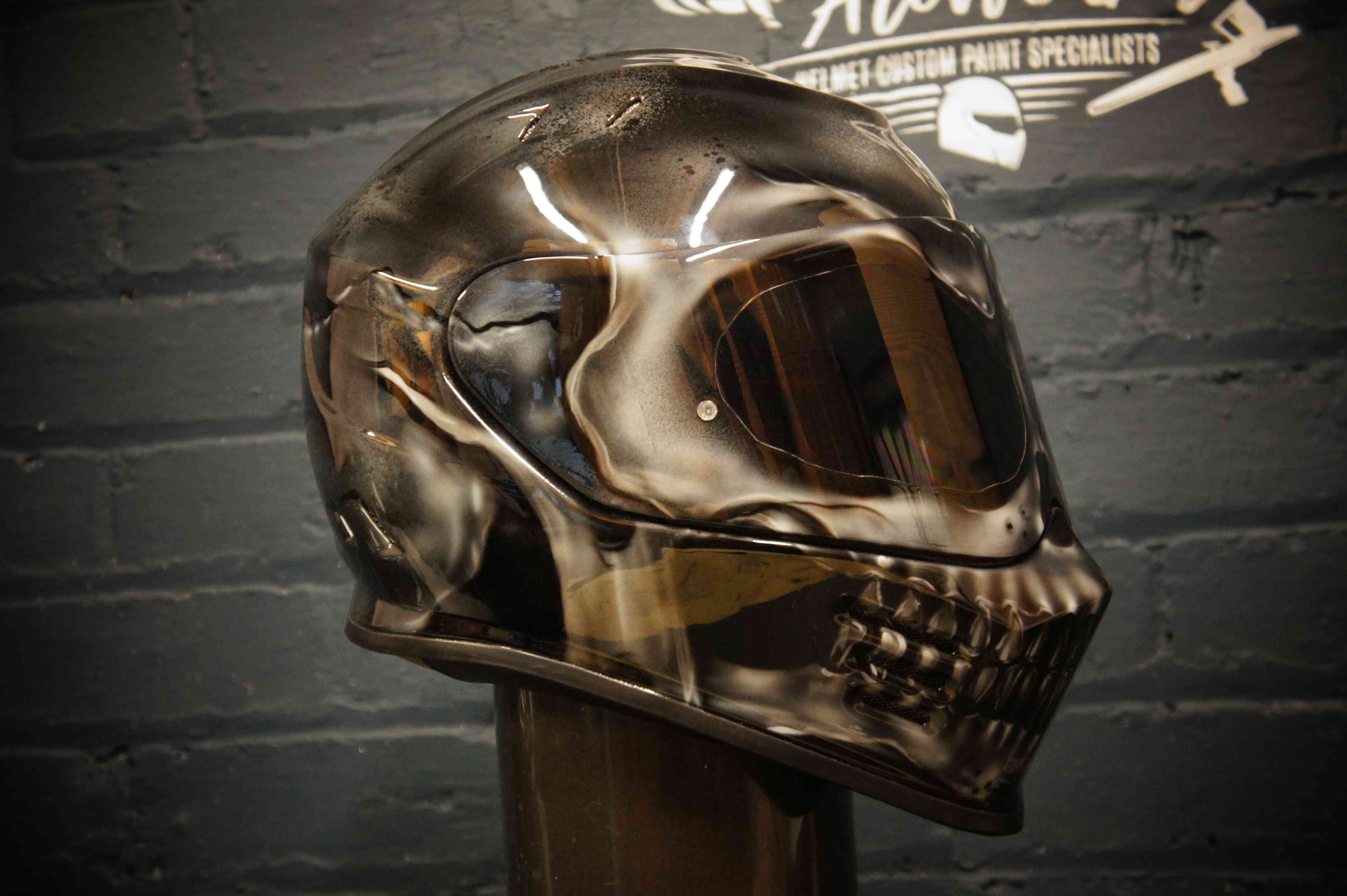 Metallic chrome skull motorcycle helmet with anatomical death head design, reflective silver finish and dark visor
