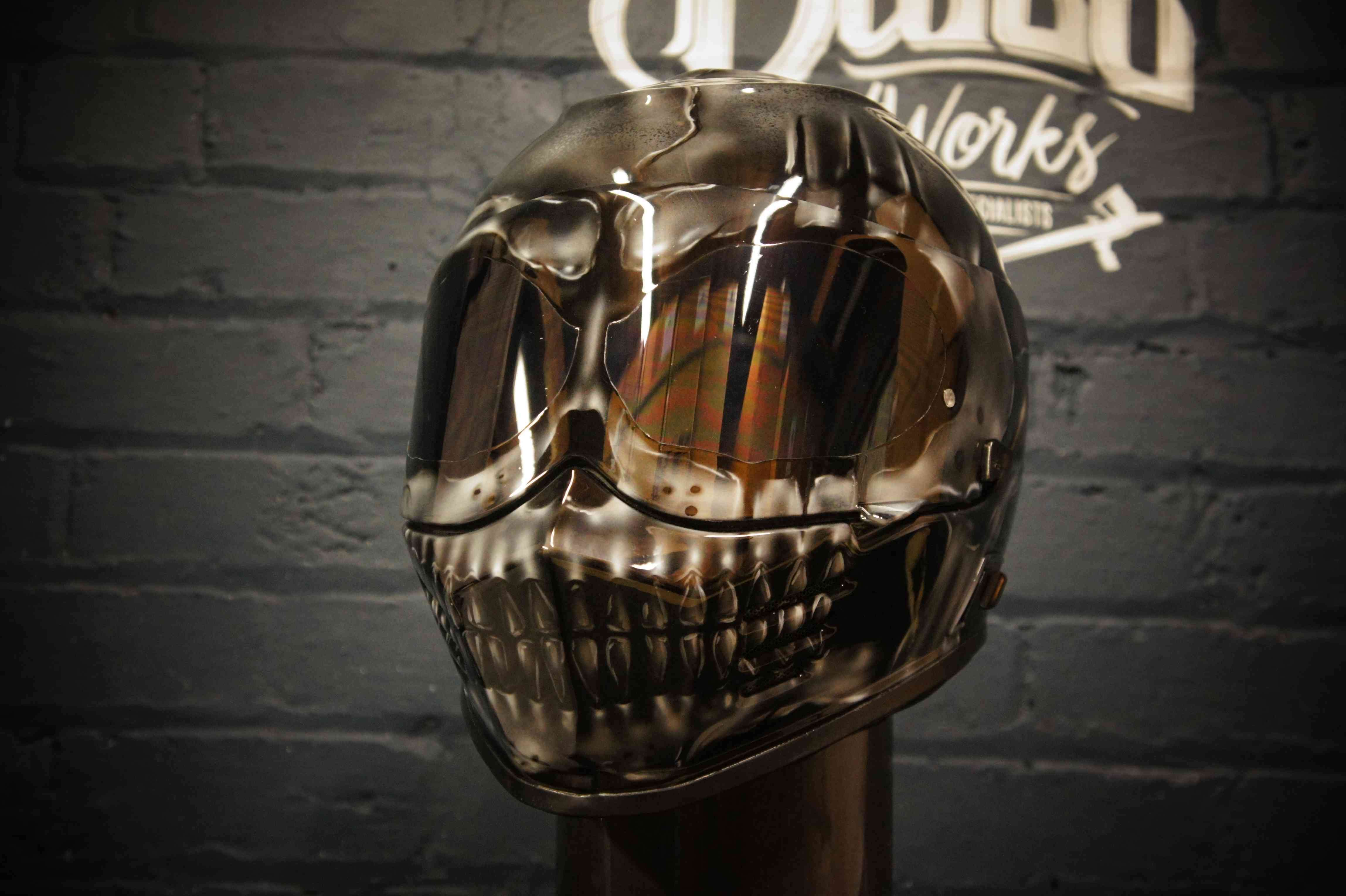 Chrome metallic skull motorcycle helmet with reflective silver finish, detailed anatomical skull face with jaw and teeth painted