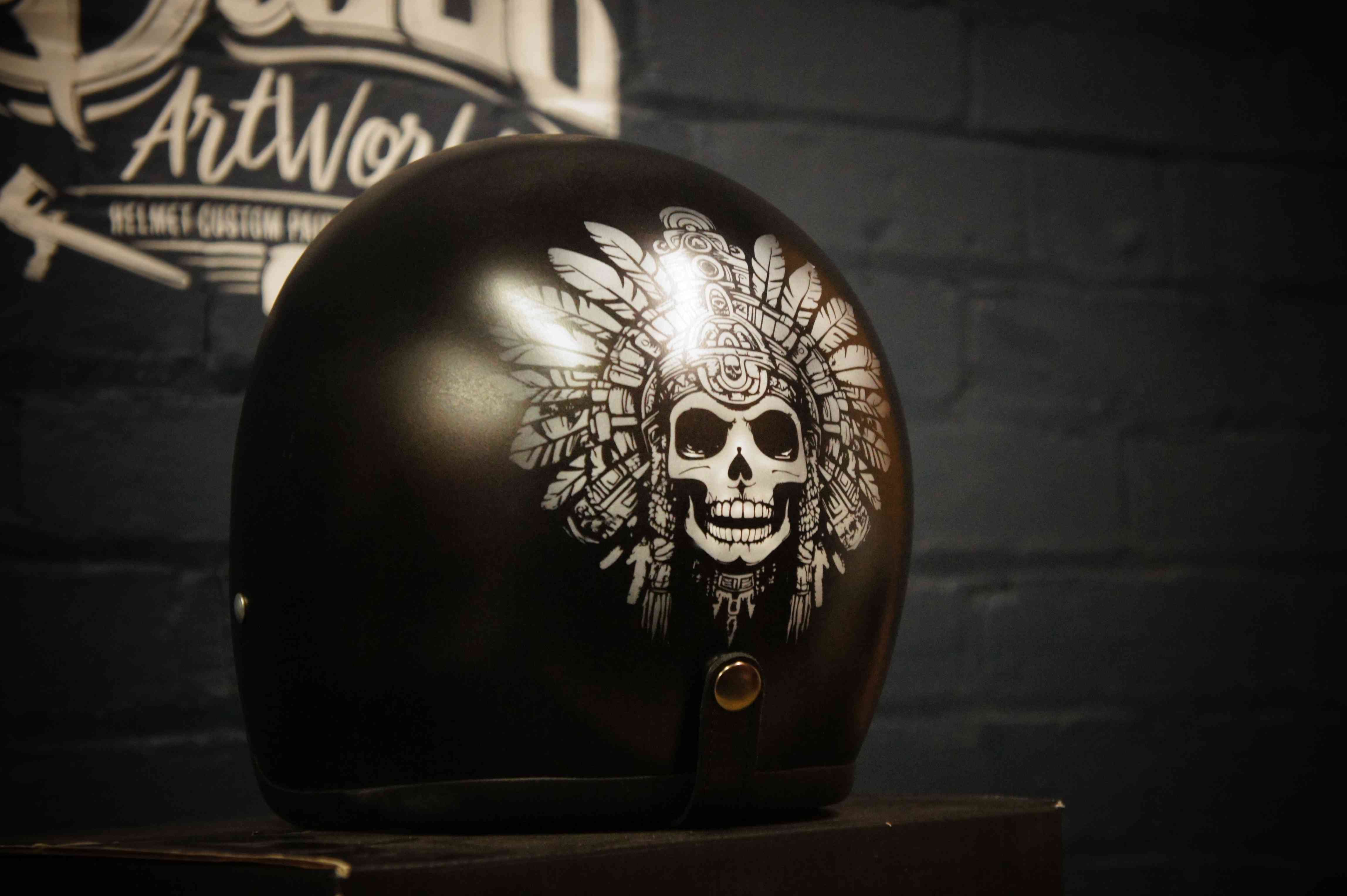 Black motorcycle helmet with detailed white Native American chief skull wearing feathered headdress custom airbrush artwork