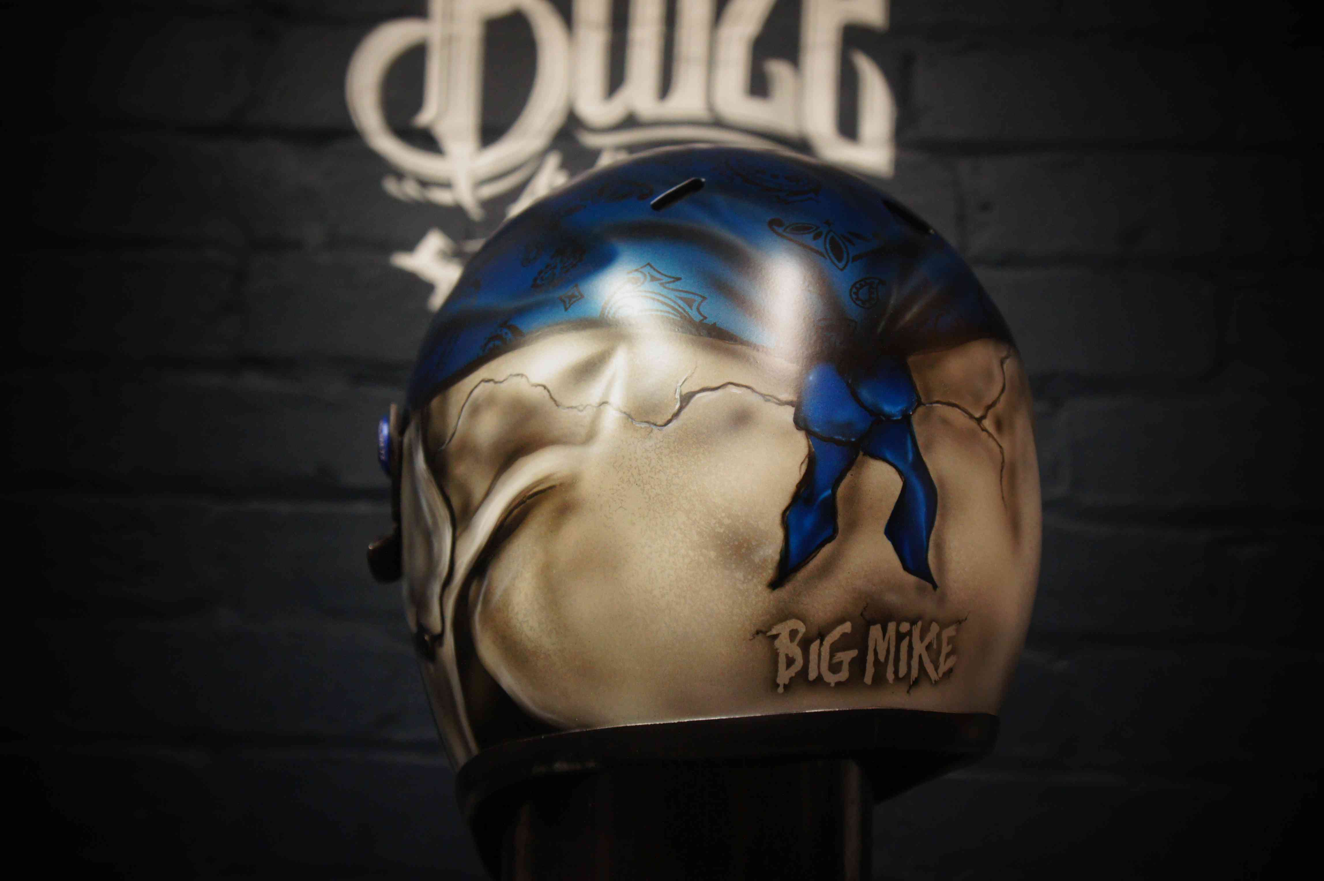 Custom painted motorcycle helmet featuring realistic 3D skull design in blue and cream colors with Big Mike memorial text