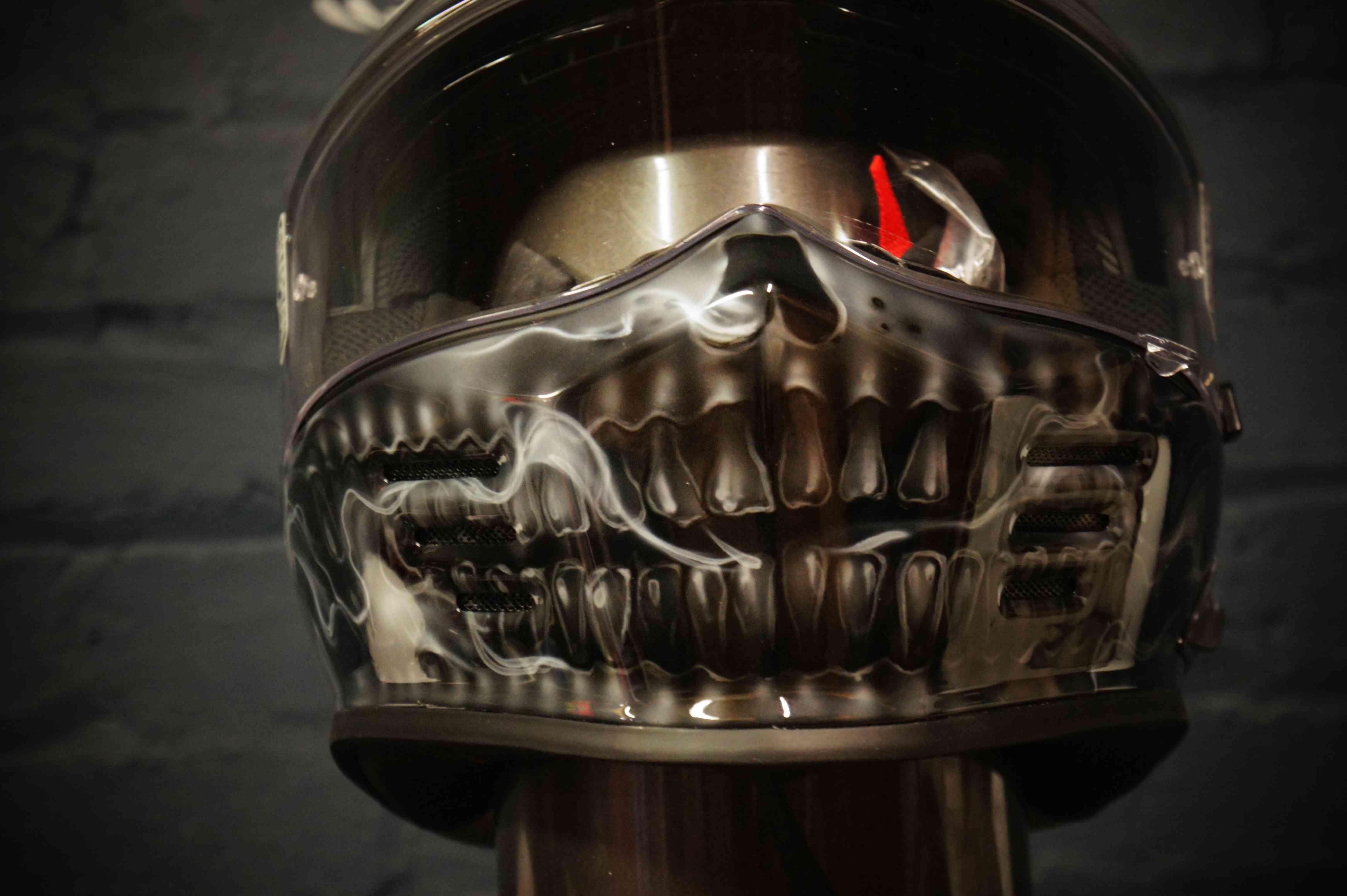 Chrome metallic skull jaw design airbrushed on black motorcycle helmet with realistic anatomical teeth and bone structure