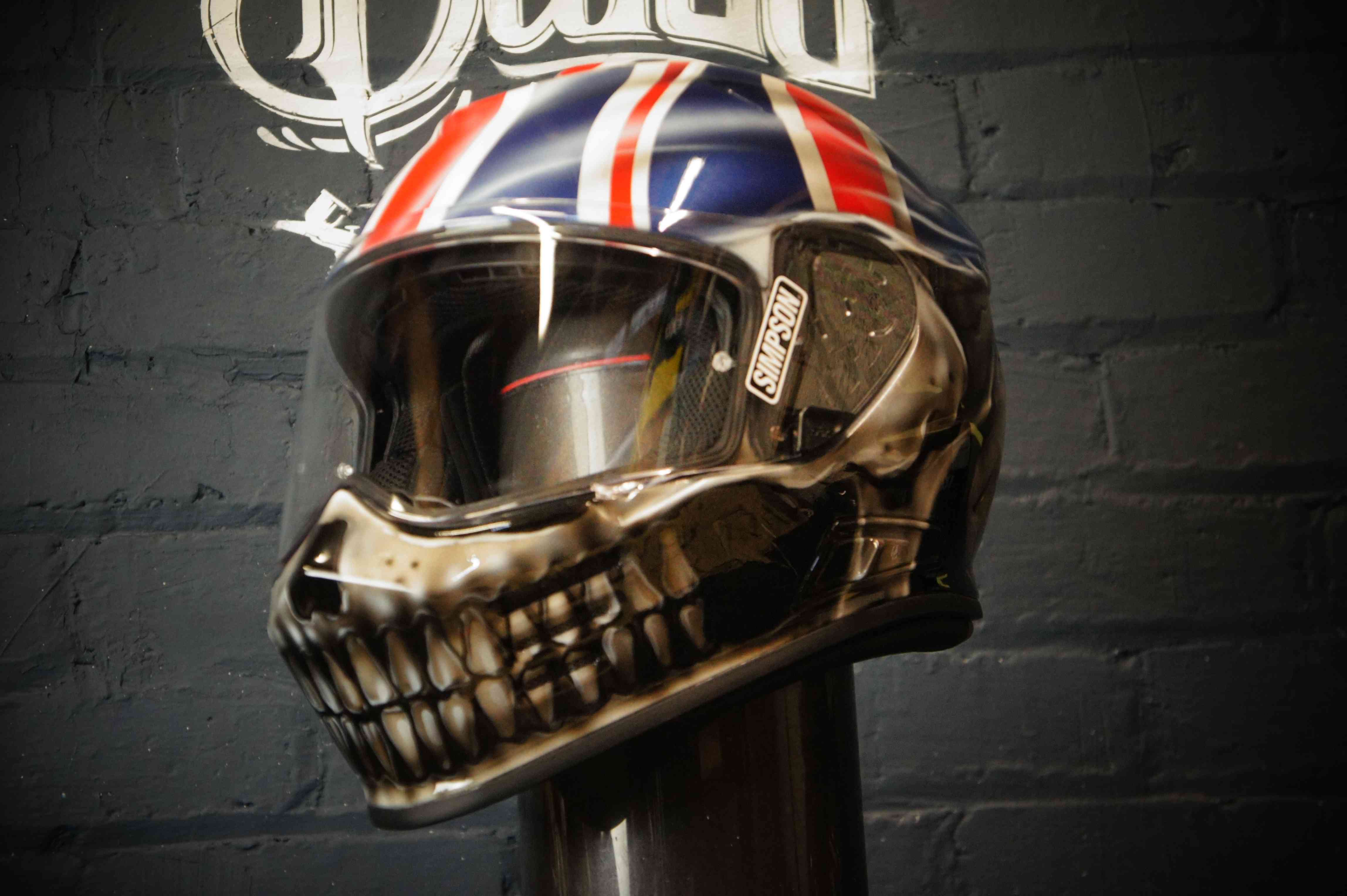 Chrome metallic skull helmet with Union Jack flag design, realistic anatomical skull features with British flag painted on top