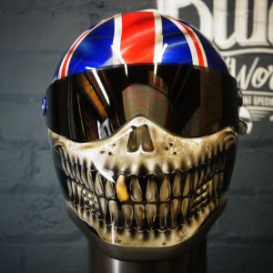 Union Jack motorcycle helmet with detailed skull and teeth airbrush design, British flag top, realistic bone jaw artwork