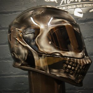 Metallic chrome skull motorcycle helmet with anatomical death head design, reflective silver finish and dark visor
