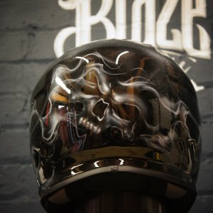 Black motorcycle helmet with chrome reflective skull design, distorted metallic finish with glossy clear coat